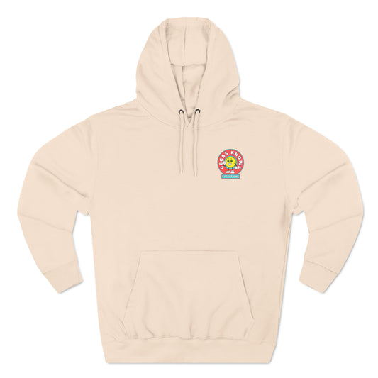 Circle pocket design with an animated coin that has dollar sign eyes that reads Vegas Knows Everything.  Peach hoodie.